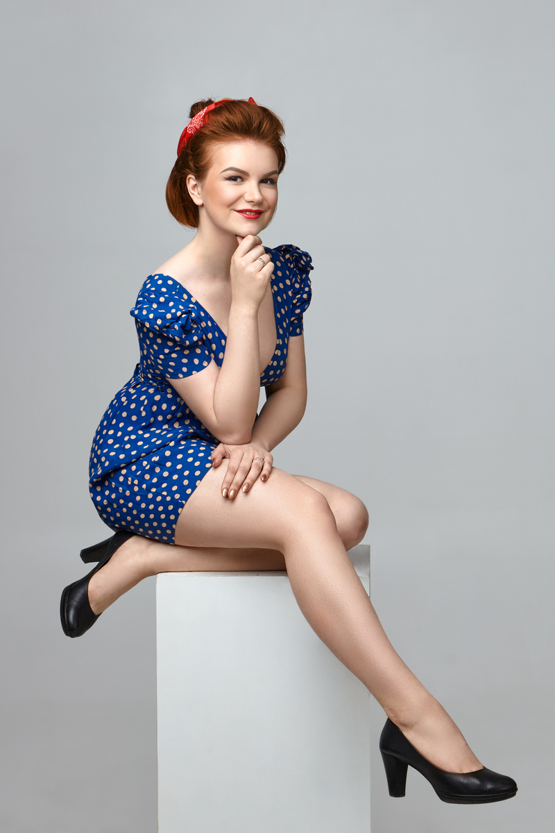 Fashionable playful pin up girl with bright make up expressing j